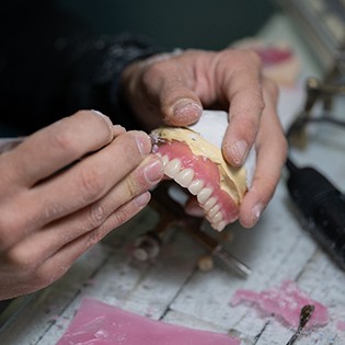 technician hands making a full denture
