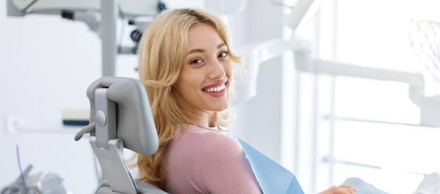 Happy female dental patient looking over her shoulder