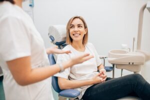 patient talking with the dentist and smiling in the chair